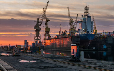 Ship repair at the ship repair yard during a spectacular sunrise - 750421811