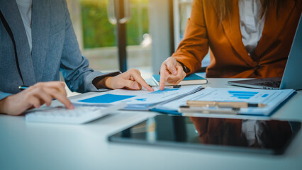 Business team meeting, members check progress, share suggestions, and offer opinions. Dressed in formal suits, team collaborates to enhance decision-making and drive successful business outcomes.