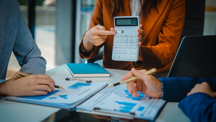 Business team meeting, members check progress, share suggestions, and offer opinions. Dressed in formal suits, team collaborates to enhance decision-making and drive successful business outcomes.