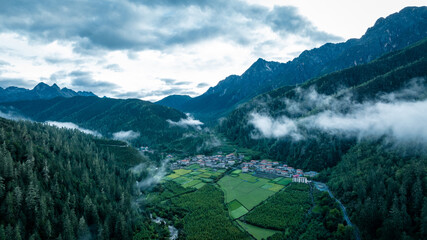 Beautiful high altitude forest mountain village landscape in the fog