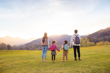 Cheerful young family enjoying the beautiful natural scenery