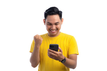 Portrait of excited handsome Asian man using smartphone, gesturing yes with clenched fist, celebrating good news isolated on white background