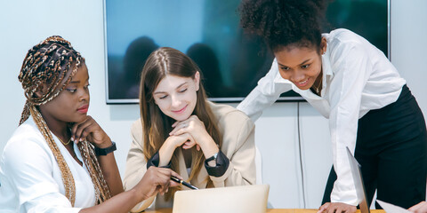 Group of marketing professionals having a meeting. Creative business team brainstorming with sticky notes. Happy business people putting their ideas together as they plan a project.