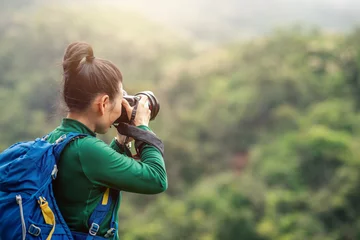  Woman photographer taking photo on spring mountain top © lzf