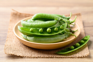 Fresh green pea in wooden bowl, Food ingredient