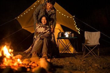 Happy young couple camping outdoors
