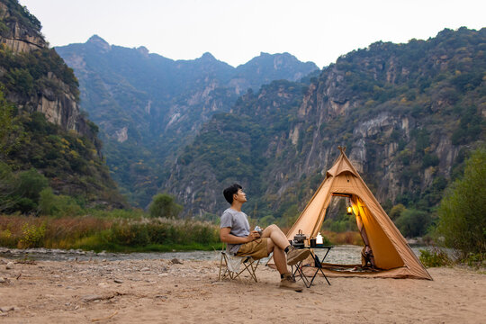Young man camping outdoors