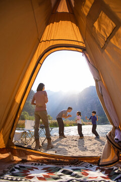 Happy young family camping outdoors