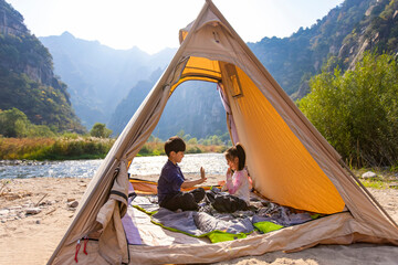 Cute Children relaxing in tent