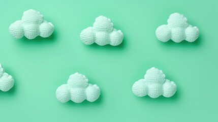 Knitted toy green cloud on a green background. Children's clothes and accessories. View from above.