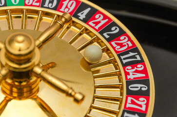 Casino roulette wheel with red and black numbers, close-up, red number 25 win