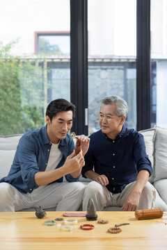 Mid adult man admiring antiques with his father