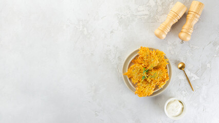 Crispy potato pancakes, draniki, Latkes or Levivot with green, spices and sour cream. Top view, copy space.