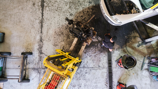 Mechanic working near forklift at workshop