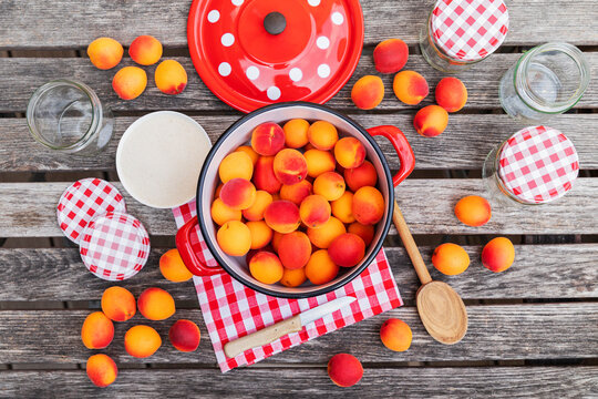 Preparation of apricot jam on wooden garden table