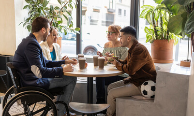 Diverse business colleagues having food at lunch break in office cafe