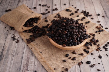wide shot high angle of coffee beans in a wooden bowl on straw matting