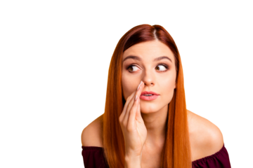 Close up portrait of  young girl tells a gossip secretly looking away and putting her hand to her mouth isolated on yellow background