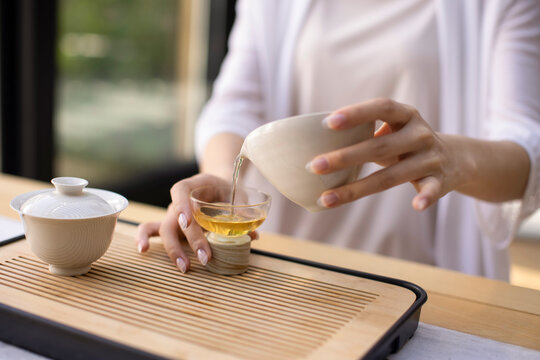 Elegant young woman drinking tea in tea room