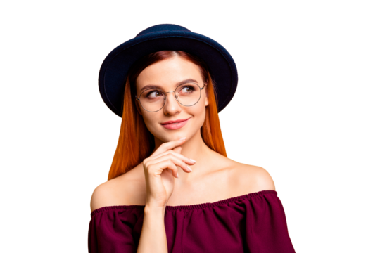 Close up portrait of charming girl looks thoughtfully away and touching the chin with her hand isolated on yellow background