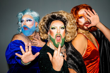 Standing drag queens showing open palms and fingers - obrazy, fototapety, plakaty