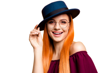 Attractive girl holding her hat and laughing look at the camera isolated on yellow background