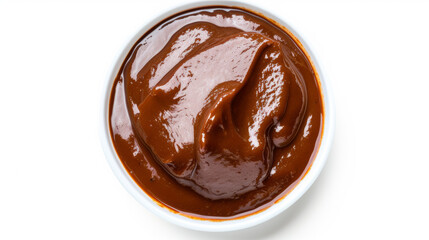 Top-down view of smooth mole sauce in a white bowl with orange trim isolated on a white background....