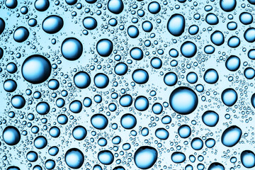 Water drops background. Wet glass surface texture. Winter window condensation problem. Bubble dew pattern. Transparent window blue raindrops. Humidity condensation texture. Blue color water.	