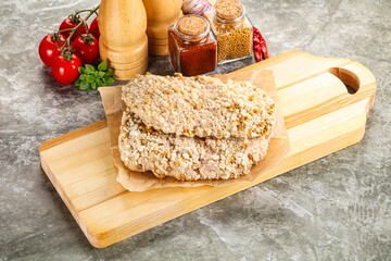 Breaded raw breaded meat schnitzel