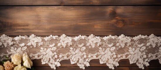 Vintage elegance: Delicate white lace adorned with intricate floral patterns atop rustic wooden surface