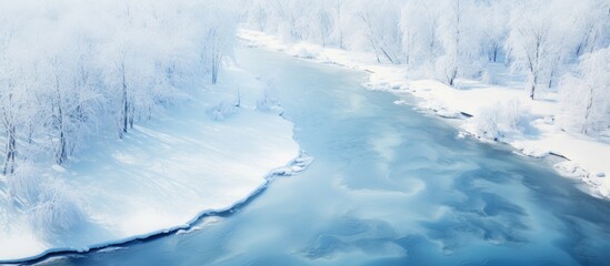 Aerial View of a Serene River Flowing Through a Snow-Covered Landscape