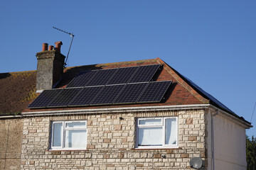 solar panels on roof of residential property. Photovoltaic cells and clean energy source on house 