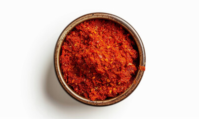 Obraz na płótnie Canvas Harissa in a small bowl, bright red, top-down view isolated on white background. Spices and condiments concept. Design for spice market advertising, cooking class, recipe ingredient highlight
