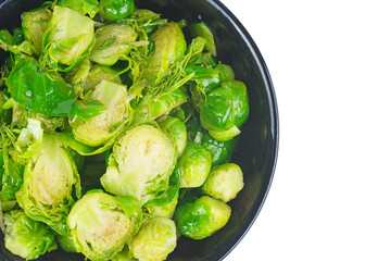 Cooked organic brussels sprouts in glass jare isolated on white background.