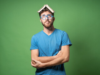 Nerdy Man with Book on Head and Blue Glasses