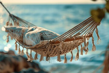 A peaceful hammock hanging from a tree by the ocean. Ideal for travel and relaxation concepts