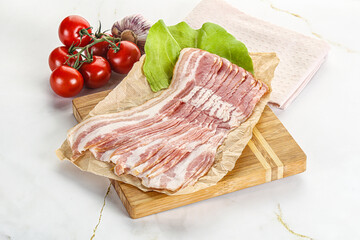 Sliced pork bacon oved board