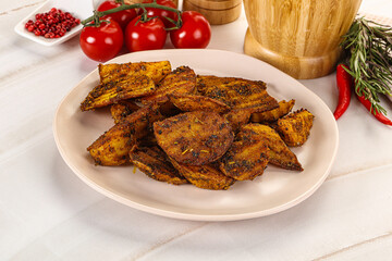 Golden baked potato Idaho with spices