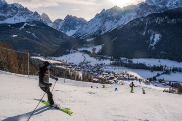 Skiers in the Three Peaks (Drei Zinnen) ski resort in the UNESCO World Heritage site Dolomites in...
