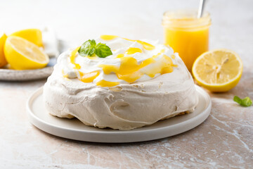 Traditional Pavlova dessert with lemon curd