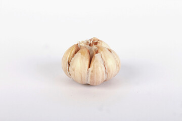 Unpeeled raw garlic isolated on white background