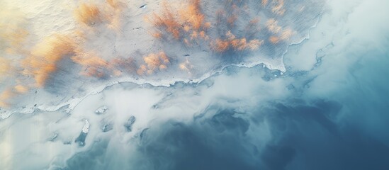 Fototapeta na wymiar Aerial View of Tranquil Frozen River Amidst Spring Thaw Creates White and Orange Patterns
