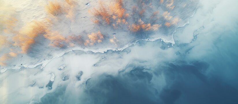 Aerial View of Tranquil Frozen River Amidst Spring Thaw Creates White and Orange Patterns