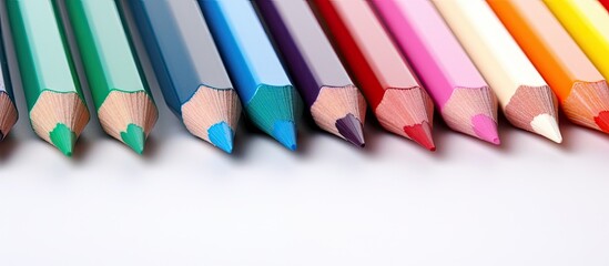 Vibrant Assortment of Colored Pencils in a Box on Clean White Background - obrazy, fototapety, plakaty