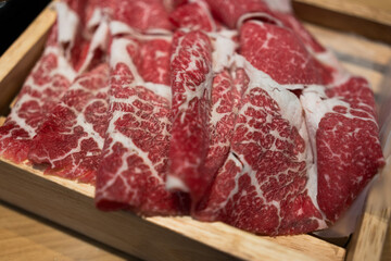 Premium raw beef sliced wagyu marbled beef in wood box served for Sukiyaki and Shabu
