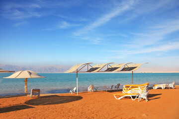  Dead Sea, the orange sand and beach chairs