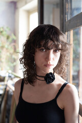 portrait of a young beautiful woman with curly hair in the studio