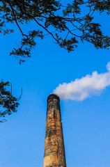 The chimney of brick field emitting heavy smoke with unhealthy carbon di oxide responsible for...