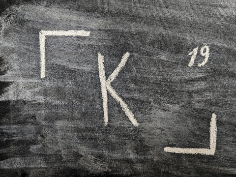 The chemical element is potassium with a serial number from the periodic table. Chalk drawing.