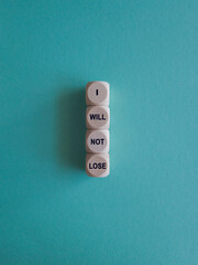 I will not lose symbol. Wooden cubes with text I will not lose. Beautiful blue background, copy space. Positive Winning Quote. Business, motivational concept.